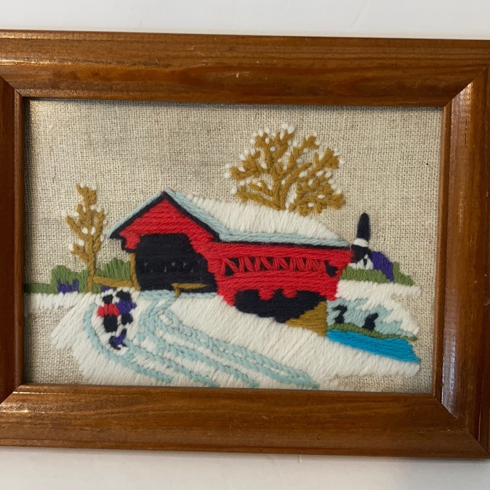Vintage needle point covered bridge in snow